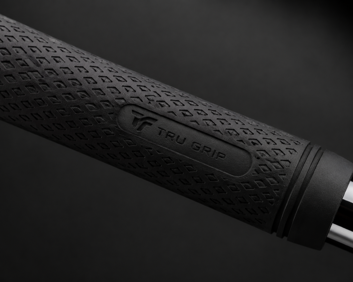 Close-up of custom rubber golf grip showing texture pattern and embossed brand logo